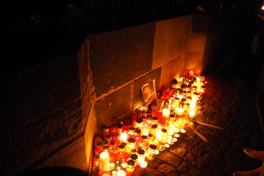 lighted candles memorial stone bridge