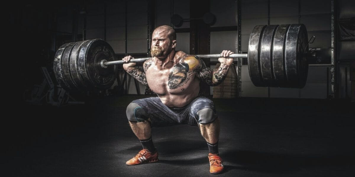 man squatting barbell exercise
