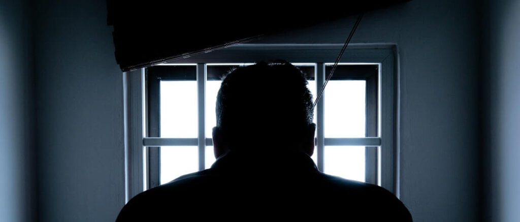 A man by a prison window