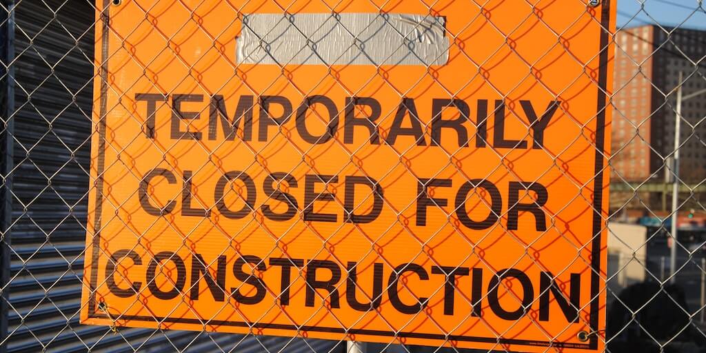 Temporarily closed for construction sign on linked fence