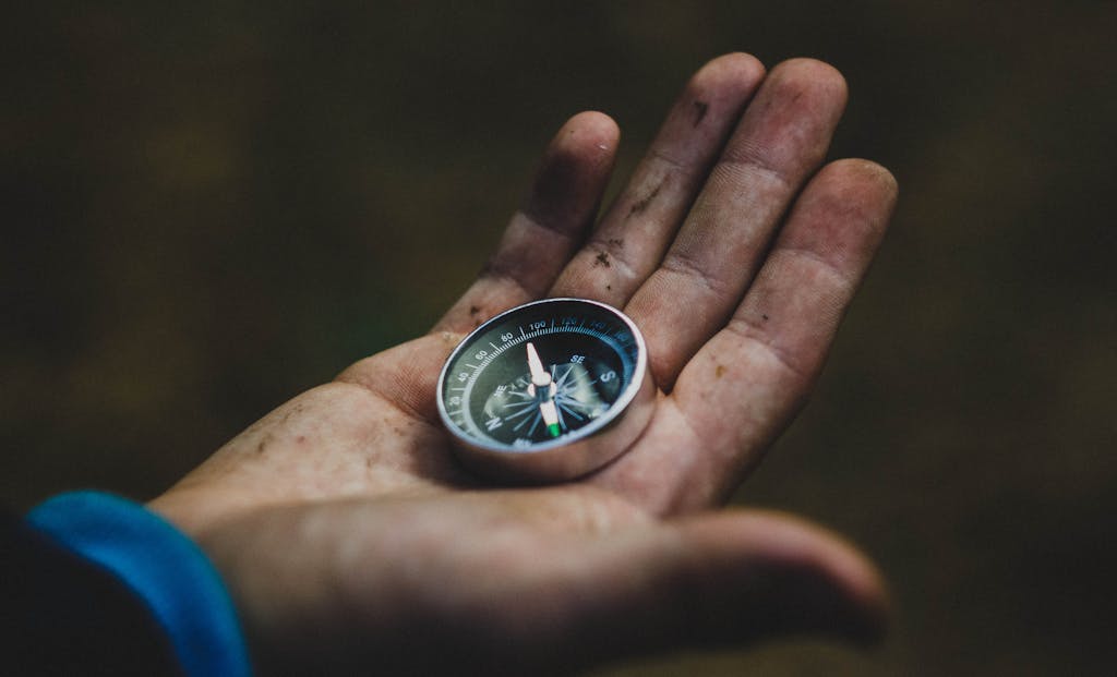 man holding a compass