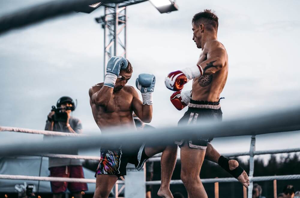 two men fighting muay thai