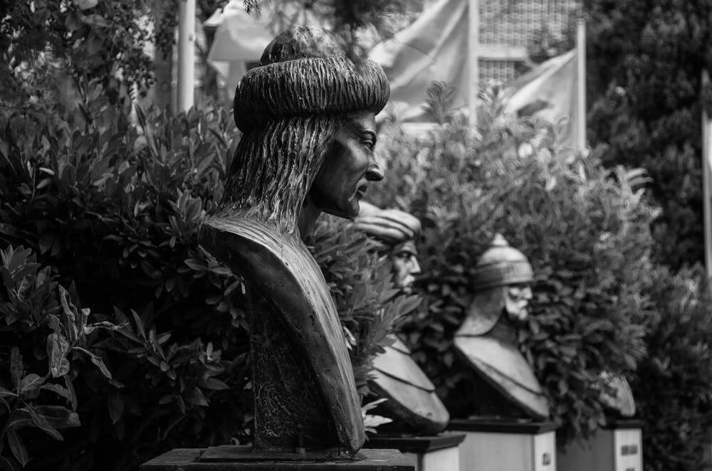 Warrior busts in a garden black and white